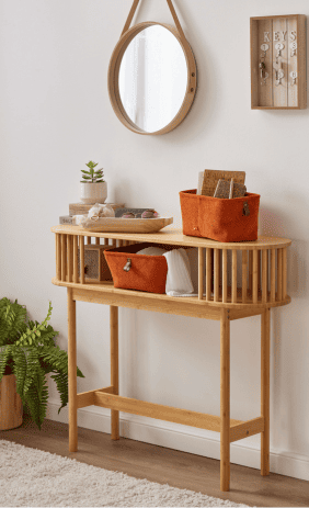 Console en bois avec paniers de rangement, miroir mural et vide-poches dans une entr&eacute;e