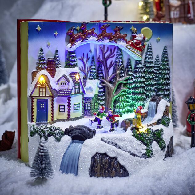 Village anim&eacute; lumineux sonore fa&ccedil;on livre ouvert avec enfants patinoire H20,5cm