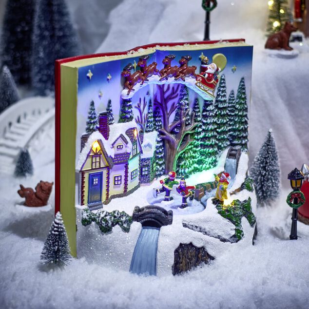 Village anim&eacute; lumineux sonore fa&ccedil;on livre ouvert avec enfants patinoire H20,5cm