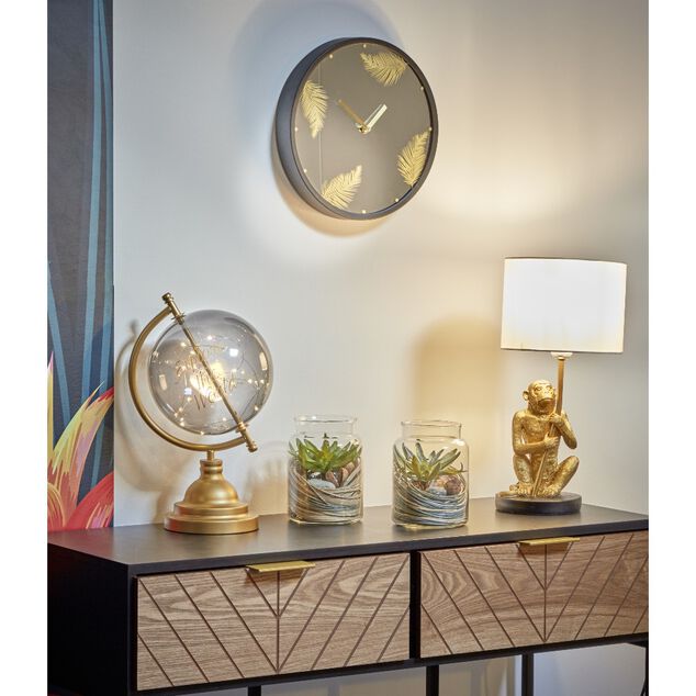 Horloge ronde motif tropical noir dor&eacute;