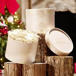 Fleur séchées dans boîte ronde rose doré